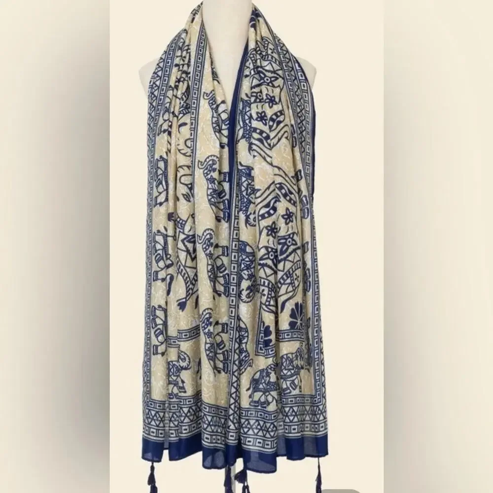 Elephant novelty print scarf with tassels at each corner. Measures 70.9” x 35.4”